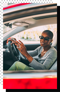 Woman driving a red car