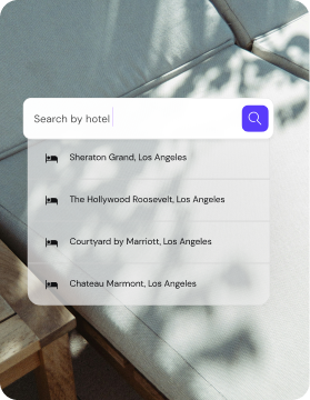 A mobile app interface displaying a "Search by hotel" search bar with a dropdown list of hotel options in Los Angeles.