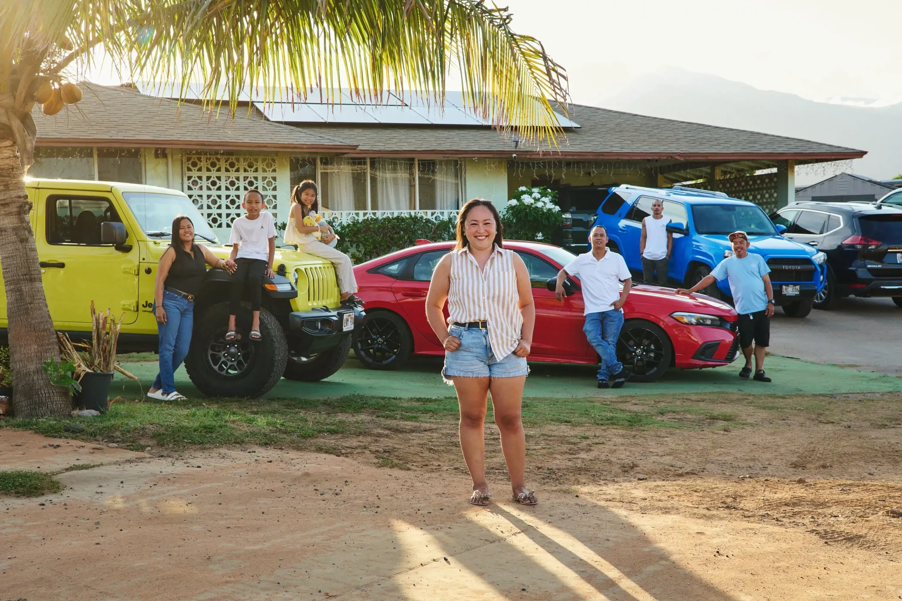 Turo host and small business entrepreneur Lucky D. smiling in front of cars