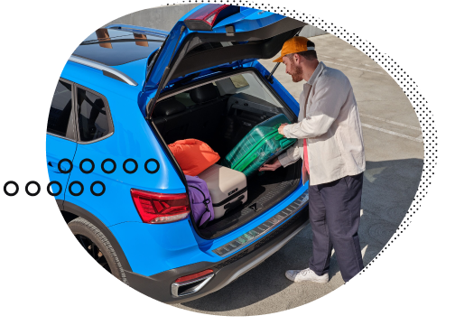 man loading luggage into trunk of a car