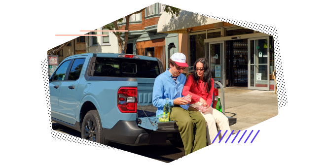 two people sitting in back of picup truck