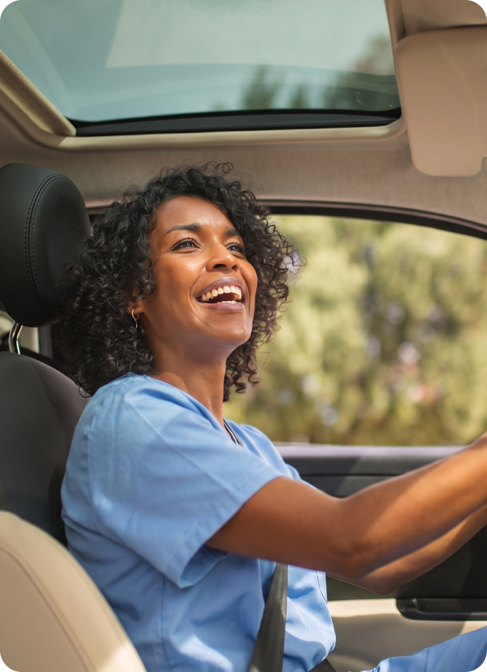 A smiling nurse in the driver’s seat.