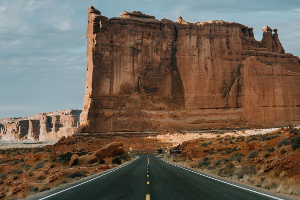 Open road with rock face in the distance
