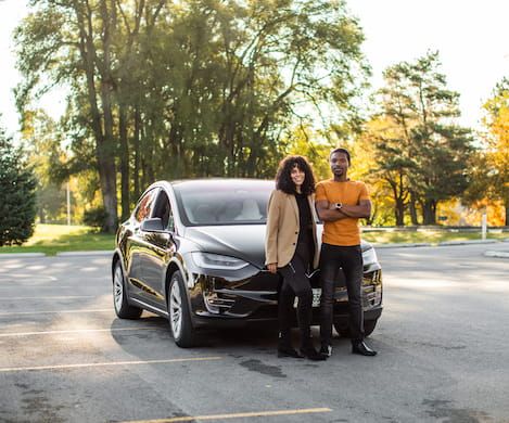 Turo car sharing entrepreneur standing in front of Audi with daughter