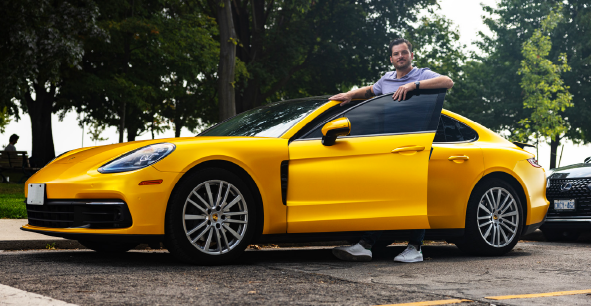 Chef Rob Rossi of Osteria Giulia standing with a yellow porsche