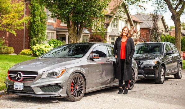 Turo car sharing entrepreneur standing in front of her rental car fleet