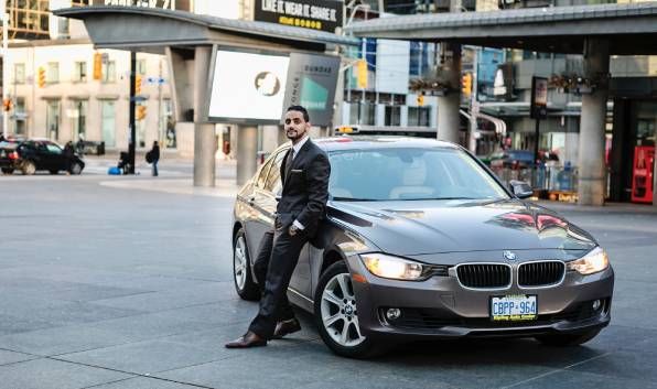 Turo car sharing entrepreneur standing with his BMW