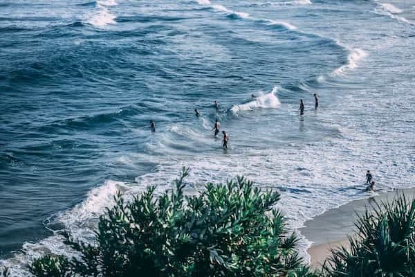 A photo of people on the beach in Ballina, a popular Ballina car hire destination.