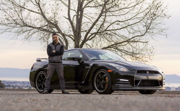 Host posing next to the passenger side of their vehicle