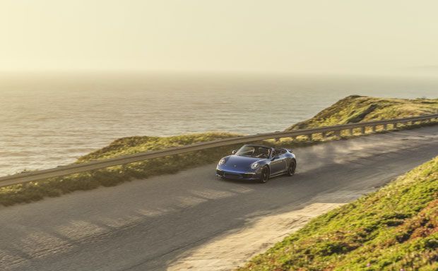 Vehicle driving on highway next to the ocean