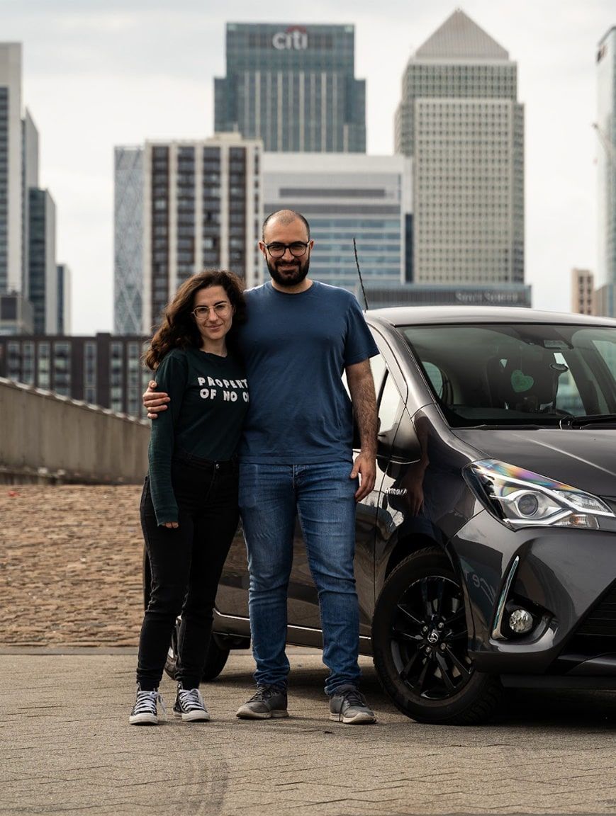 Turo car sharing entrepreneur standing in front of Audi with daughter