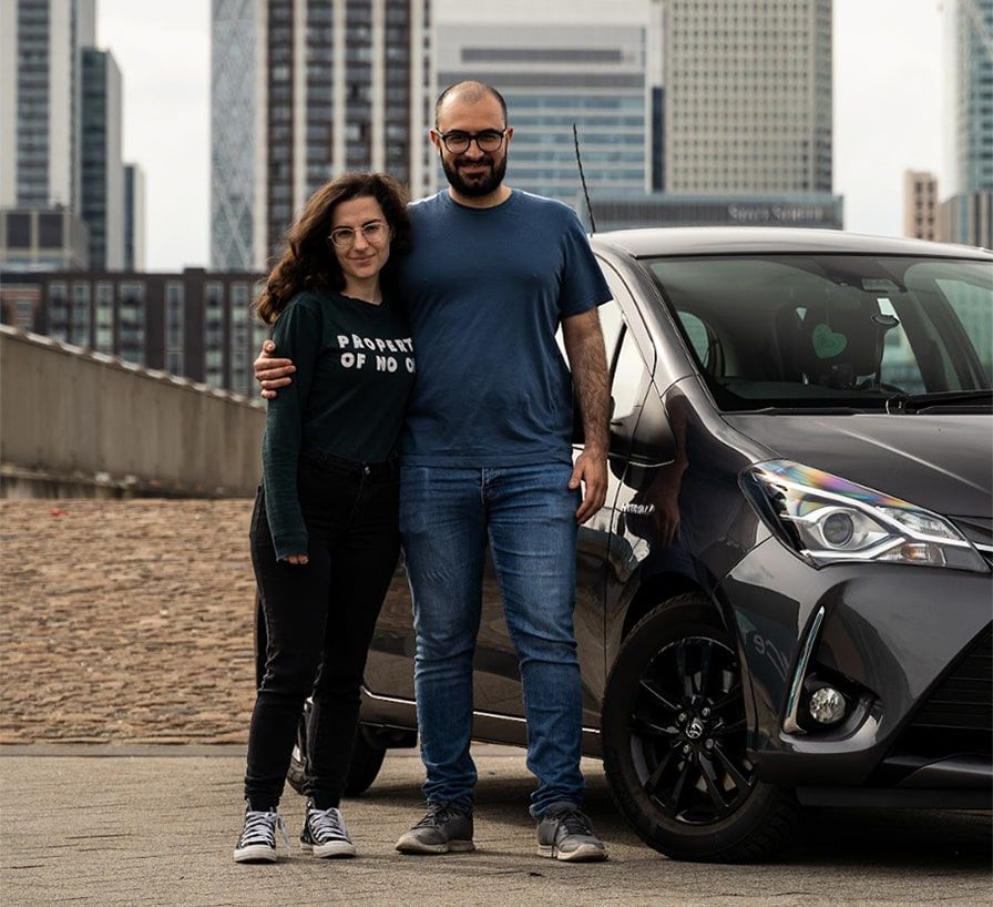 Turo car sharing entrepreneur standing in front of Audi with daughter