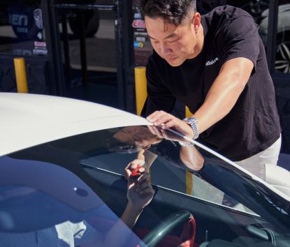 Host Chen Wang handing off key to a driver
