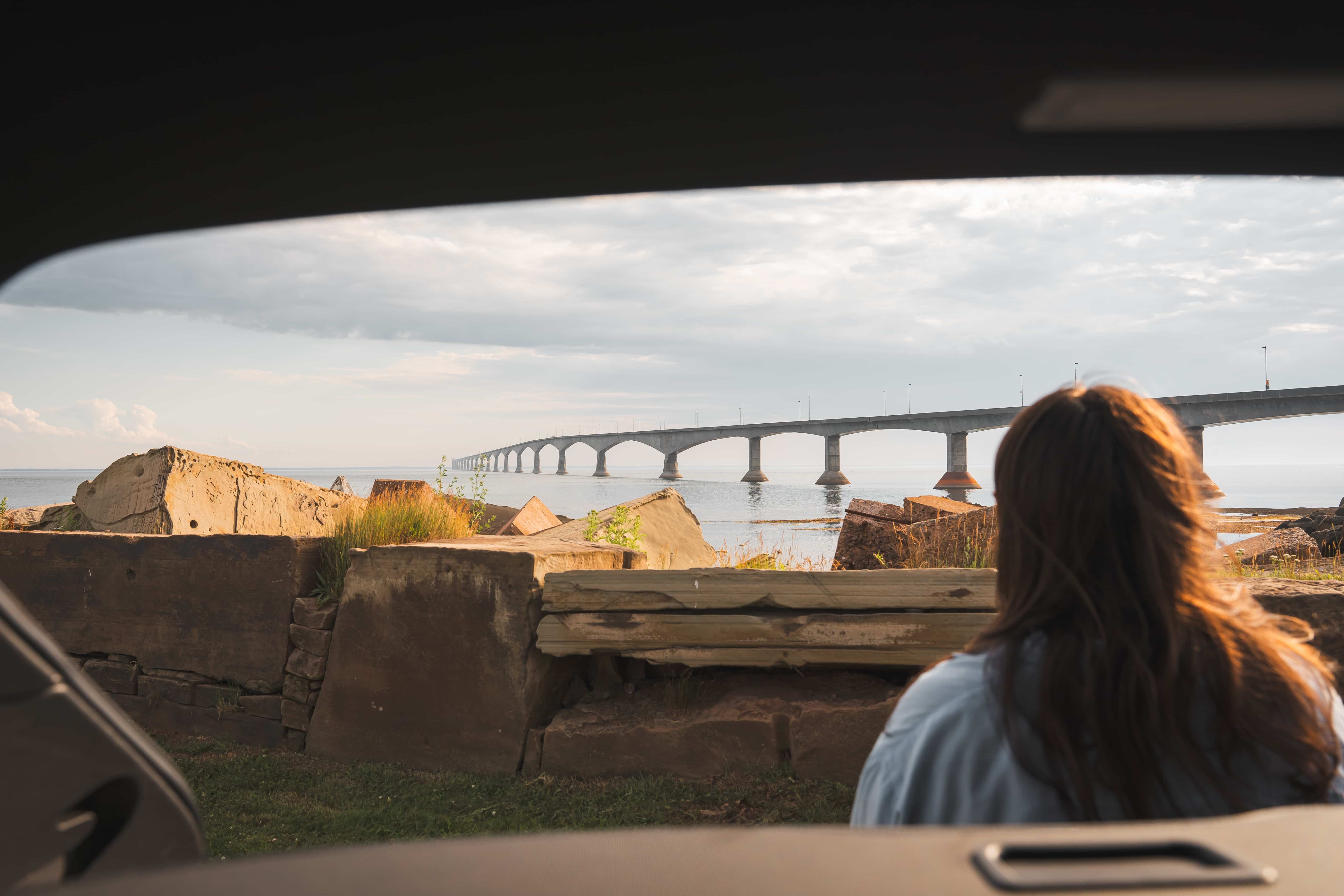 Man standing by black car looking at the view