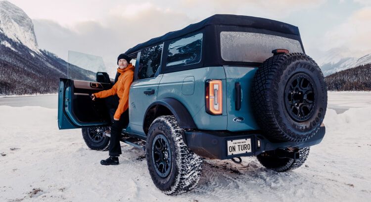 Man sitting in a Ford Bronco