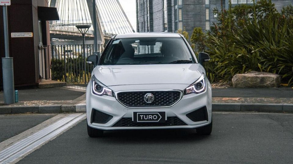 Cars parked at Sydney Harbour with Sydney Opera House behind