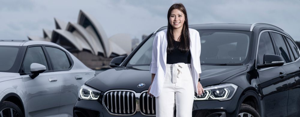 Someone who has rented their car, standing in front of fleet of cars in Sydney, Australia