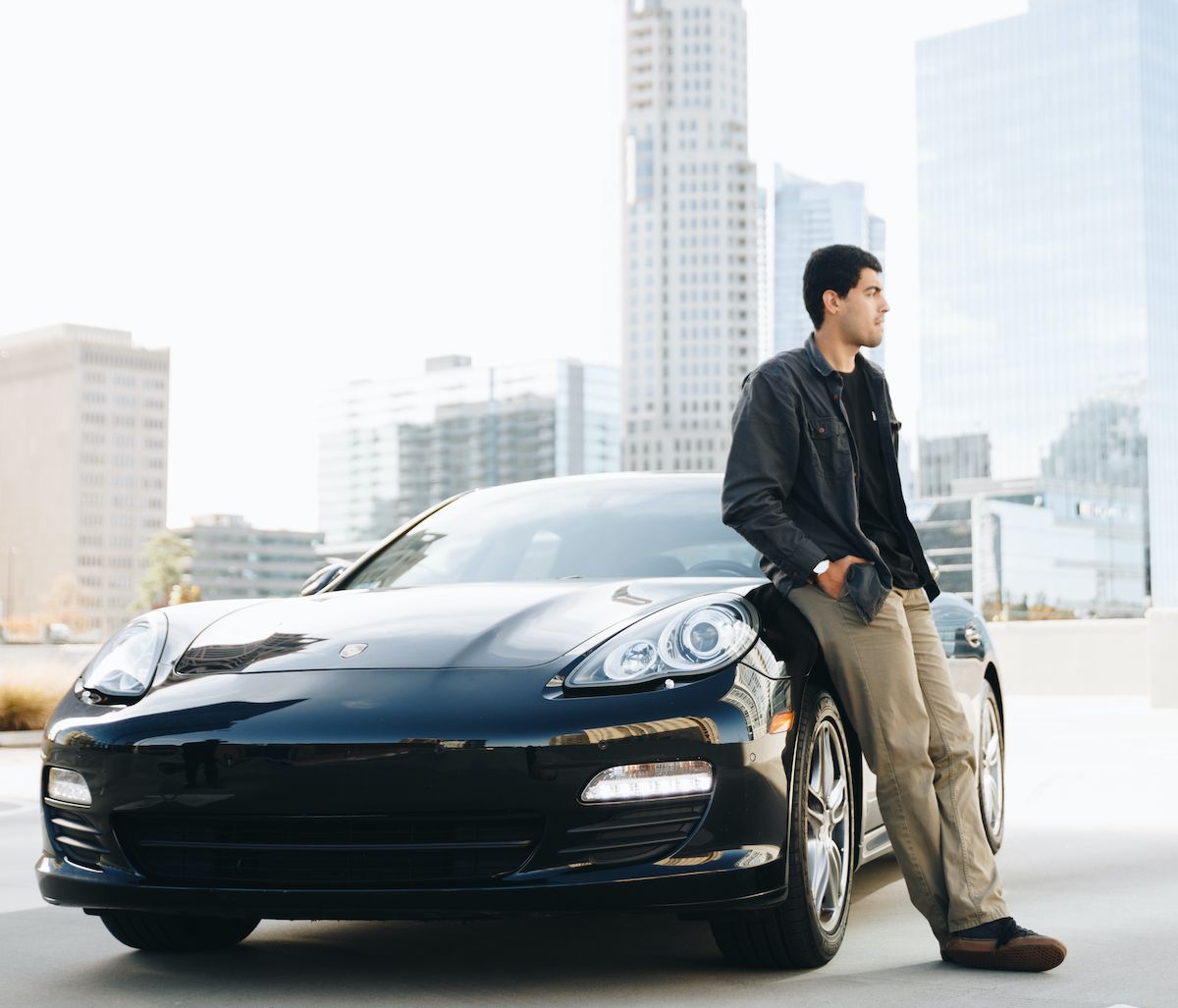 Turo car sharing entrepreneur standing next to his Porsche Panamera in New York City