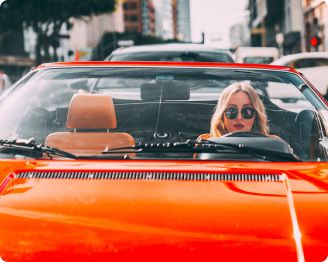 Woman in red convertible rental alternative booked on Turo