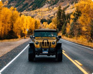 Golden Jeep rental alternative booked on Turo among golden autumn foliage