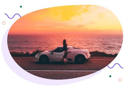 Woman with Alfa Romeo rented on Turo at sunset