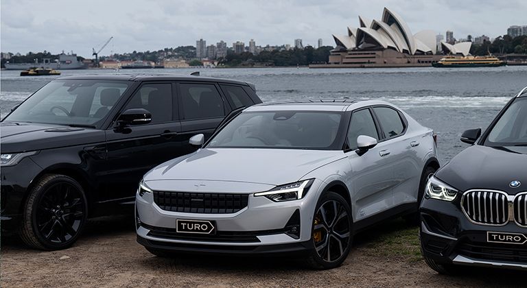 Cars parked at Sydney Harbour with Sydney Opera House behind