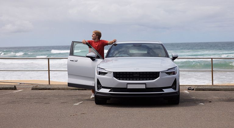 Man with Polestar 2 at the beach near Melbourne